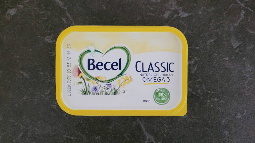 Eine Packung getestete Margarine von oben auf einer dunklen Fläche.