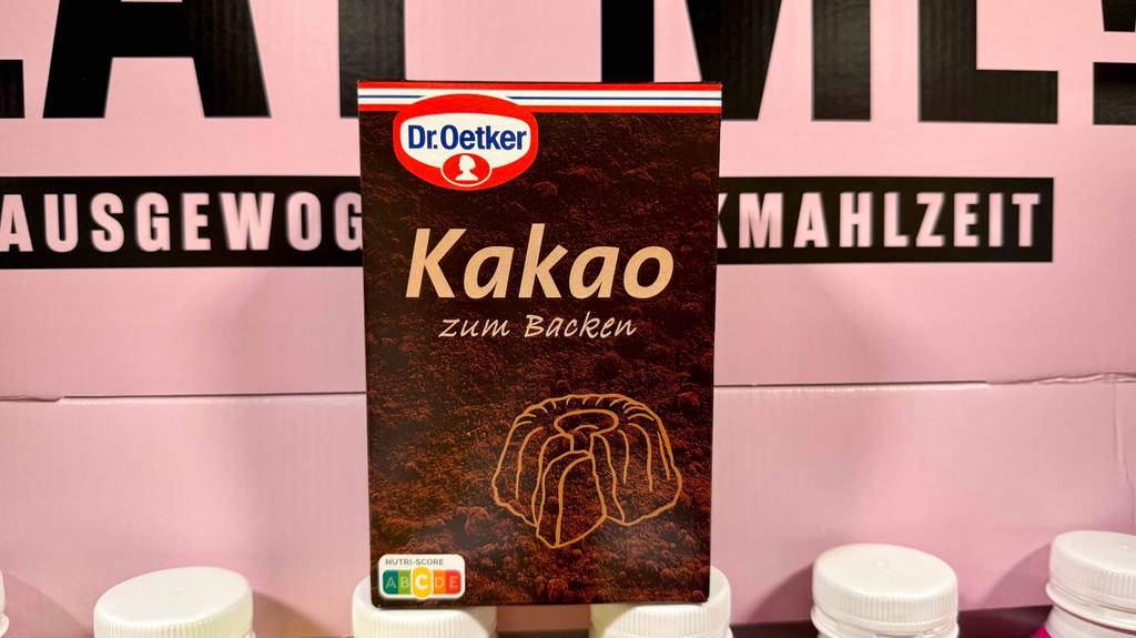 Eine Packung getesteter Backkakao steht vor einem Aufsteller.