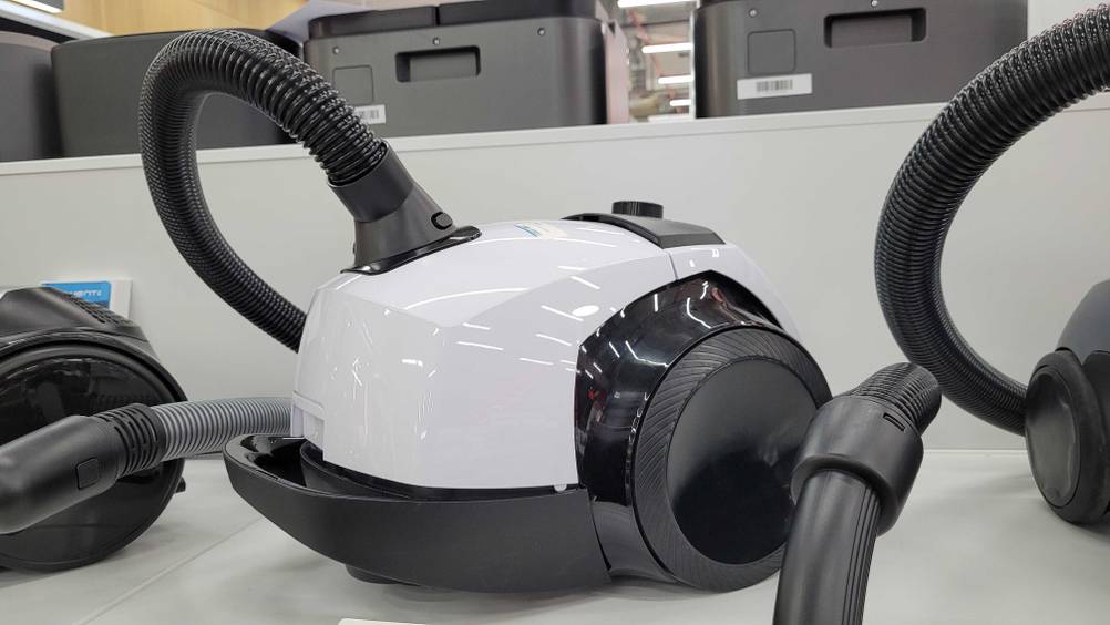 Der getestete Staubsauger mit 800 Watt steht in einem Regal neben anderen Modellen.