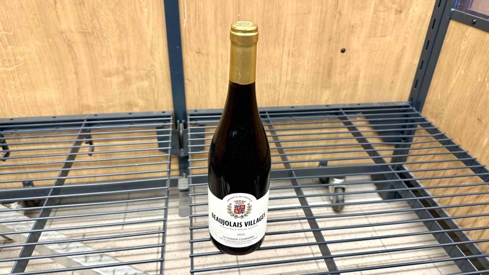 Ein getesteter Beaujolais-Wein steht in einem leeren Regal in einem Geschäft.