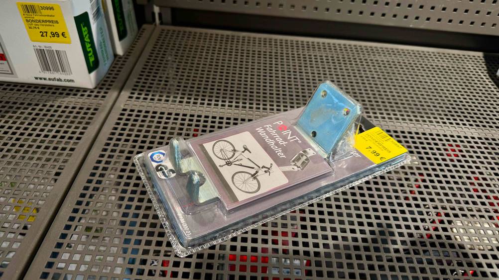 Die getestete Fahrrad-Wandhalterung befindet sich in der Verpackung, die in einem Regal liegt.
