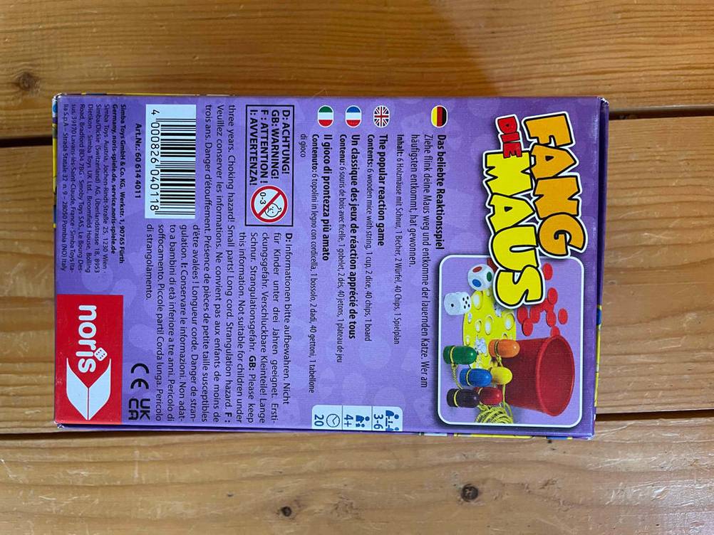 Würfelspiel getestet: Verpackungsrückseite eines Würfelspiels auf einer Holzfläche liegend.