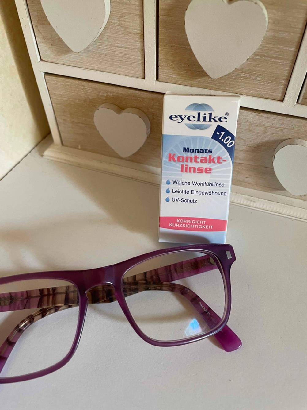 Monatslinsen im Test: Monatslinsen liegen verpackt neben einer Brille.