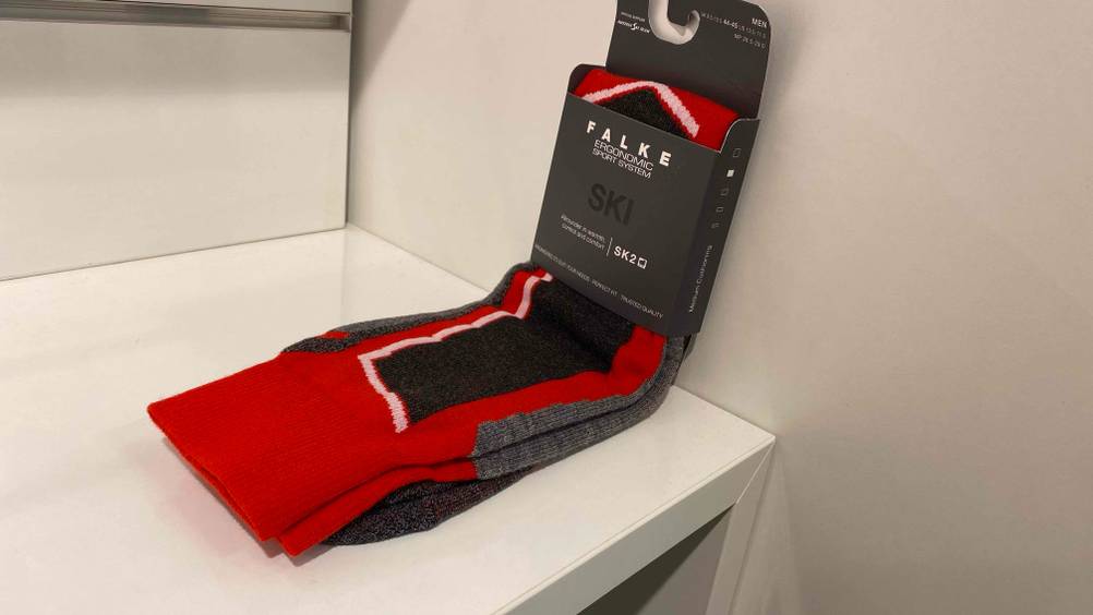 Skisocken getestet: ein Paar rot-schwarze Skisocken in Originalverpackung.