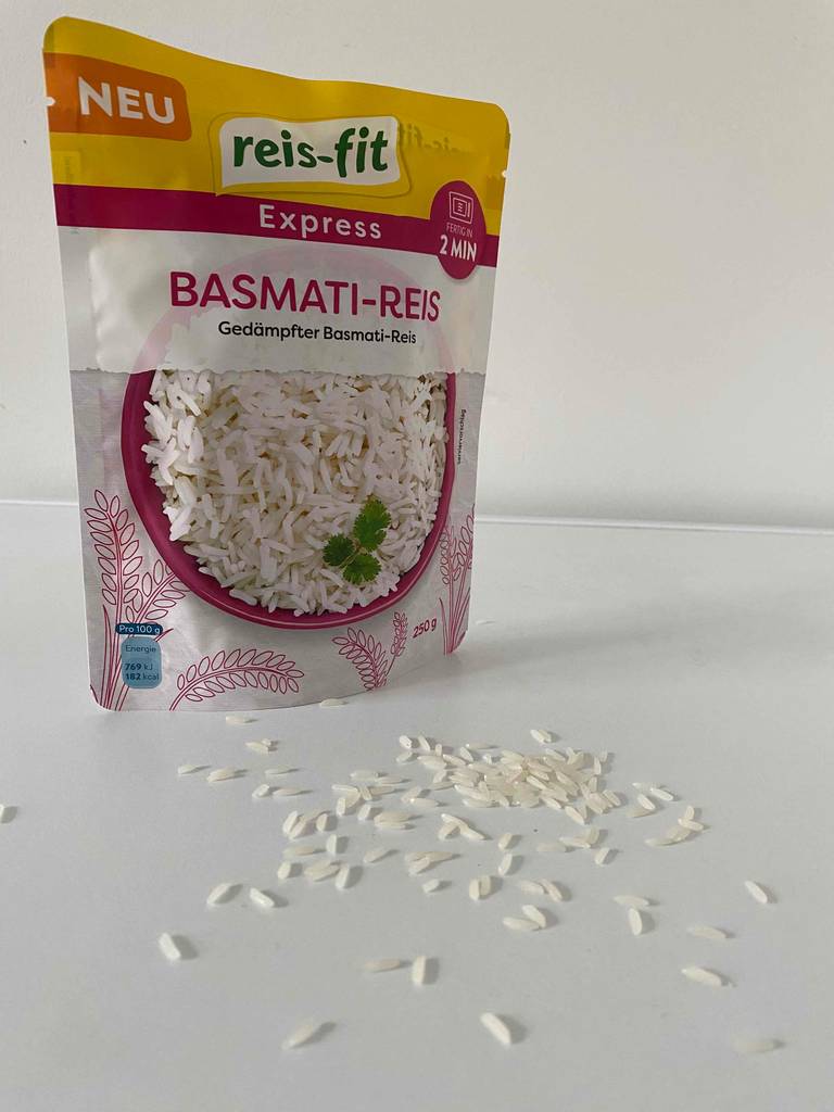 Abbildung Packung Reisfit mit Reiskörnern davor