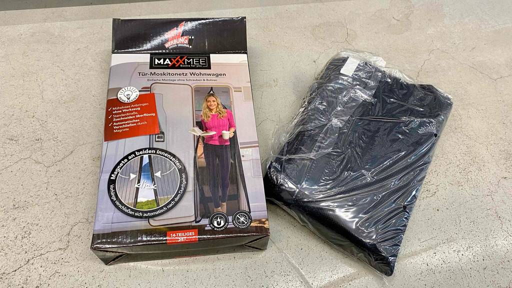 Moskitonetz getestet: ein Tür-Moskito-Netz liegt in einem Plastik neben der Verpackung.
