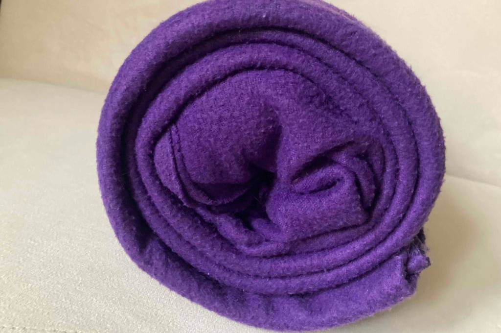 Decke mit Ärmeln getestet: Decke mit Ärmeln in Violett eingerollt.