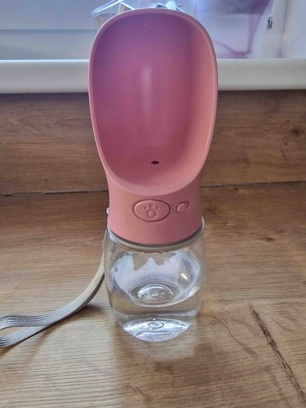 Auf einer Holzoberfläche steht eine getestete Trinkflasche für den Hund