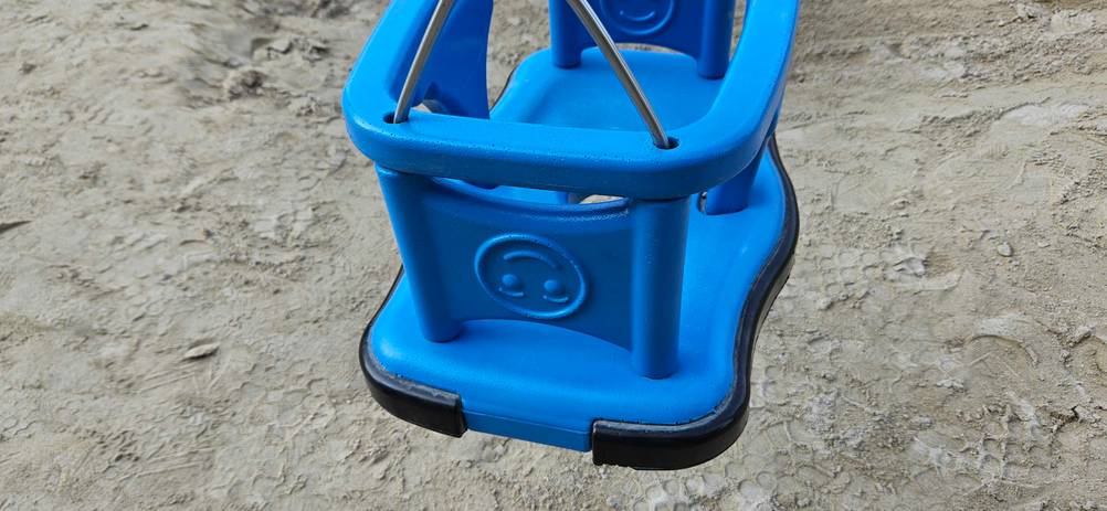 Doppelschaukel-Test: eine blaue Schaukel mit einer Umrandung als Schutz in Nahaufnahme.