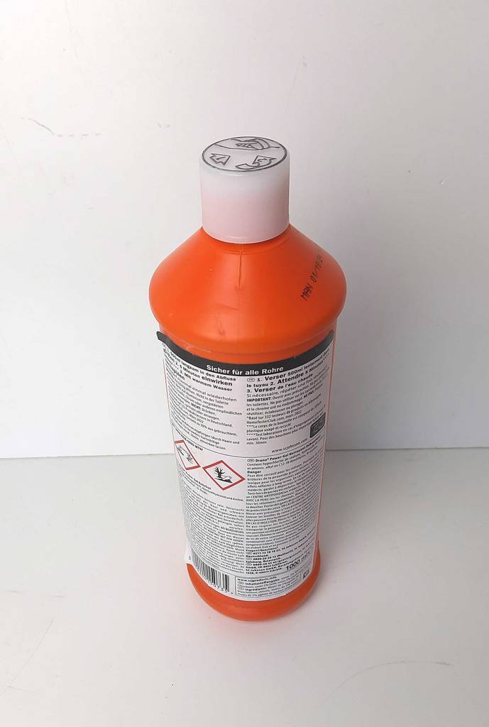 Rohrreinigung getestet: Der Drano-Rohrreiniger steht in der orangefarbenen Kunststoffflasche auf einer weißen Oberfläche.
