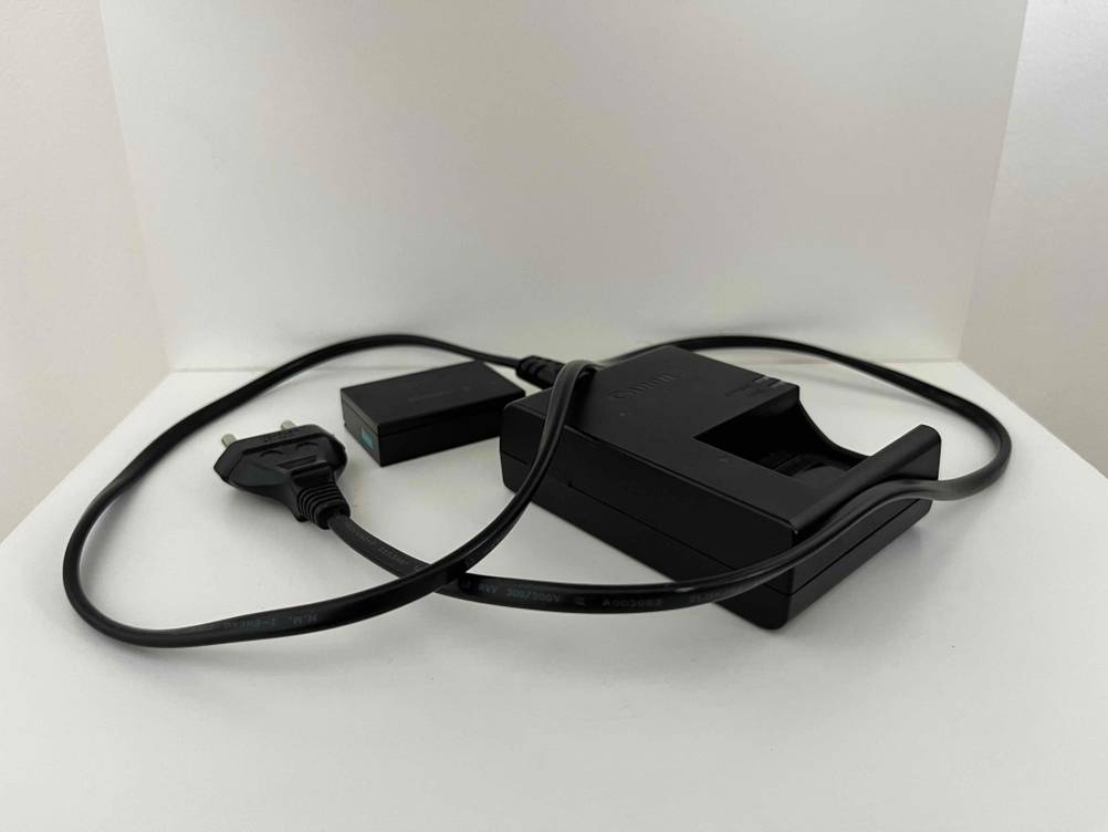 Akku-Ladegerät im Test: Ein Akku-Ladegerät mit Kabel liegen auf einer hellen Oberfläche