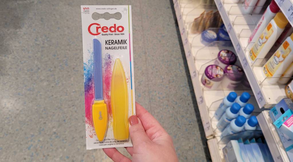 Eine getestete Keramik-Nagelfeile wird in der Verpackung in der Hand gehalten.
