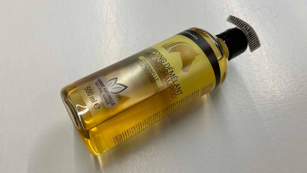 Pferdeshampoo im Test: Eine Flasche liegt quer auf einer hellen Oberfläche