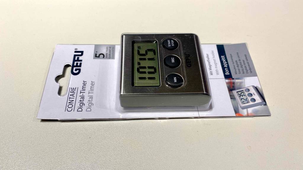 Digitaler-Kurzzeitwecker im Test: ein Digitaler-Kurzzeitwecker in der Verpackung auf einer hellen Fläche liegend.