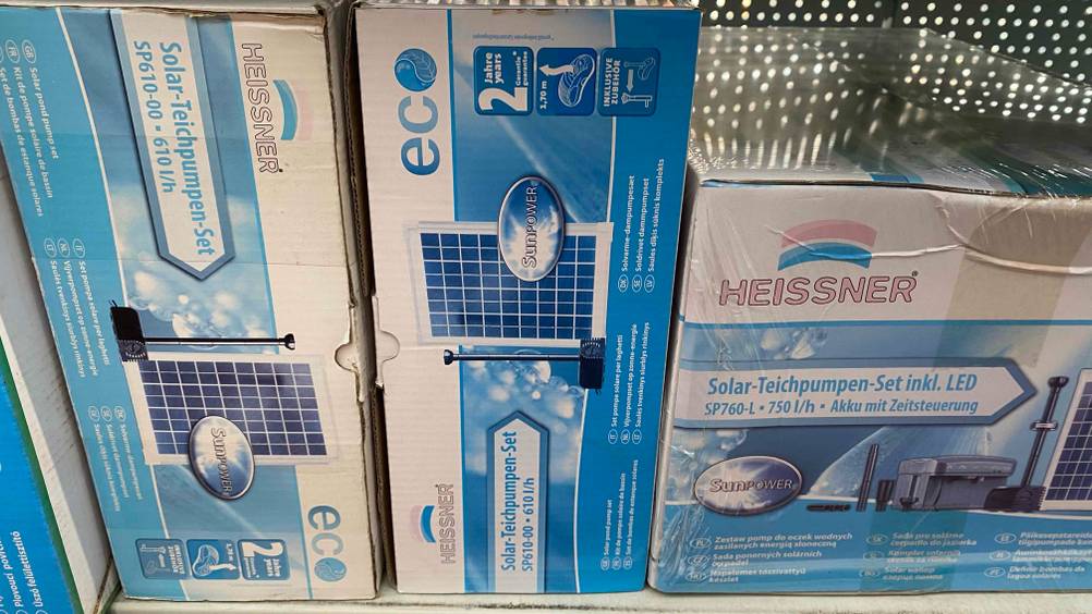 Solar-Teichpumpe getestet: Eine verpackte Pumpe neben anderen Produkten in einem Regal.