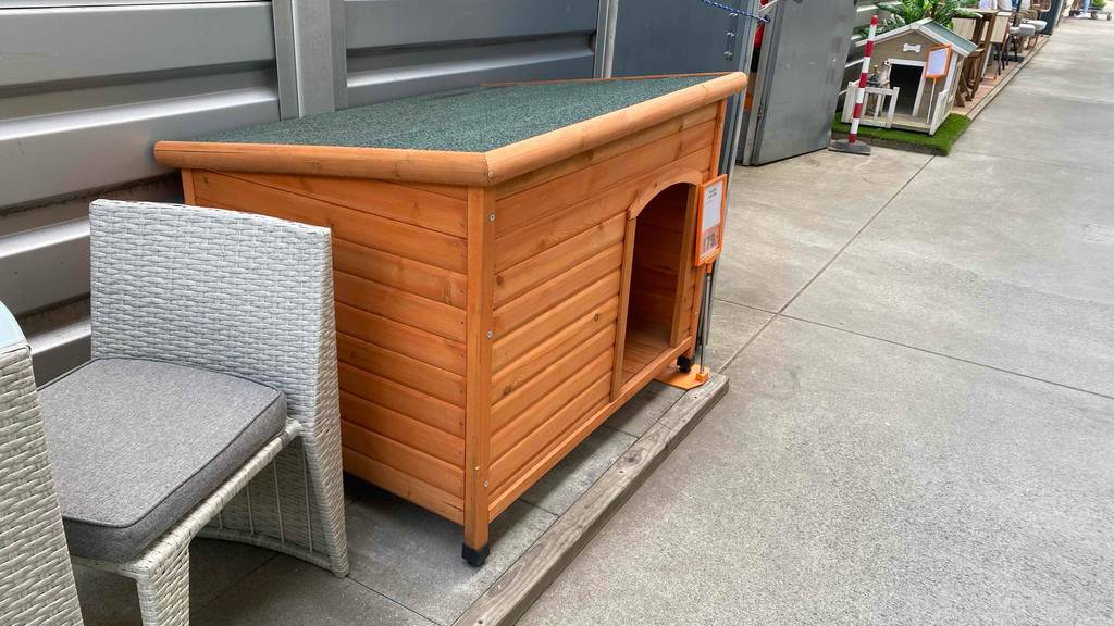 Hundehütte XXL getestet: Eine Hundehütte aus Holz steht in einem Geschäft.