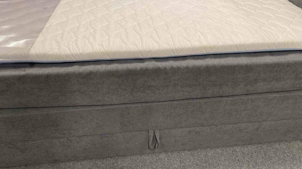 Boxspringbett-180x200 getestet: Seitenteil eines Boxspringbettes im Fokus mit einem Bettkasten.