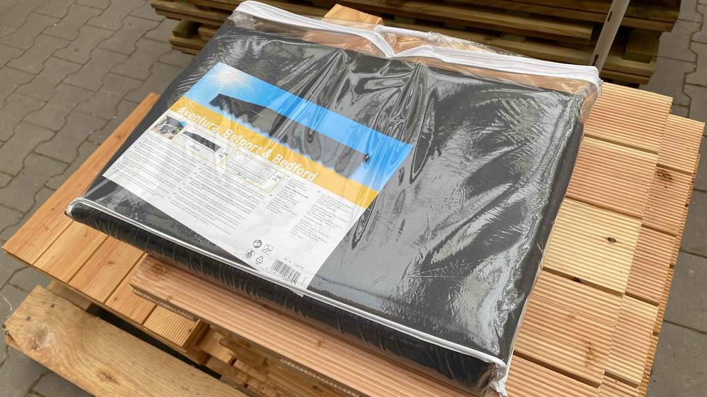 Markisenstoff im Test: eine Packung Markisenstoff liegt auf Klickfliesen.