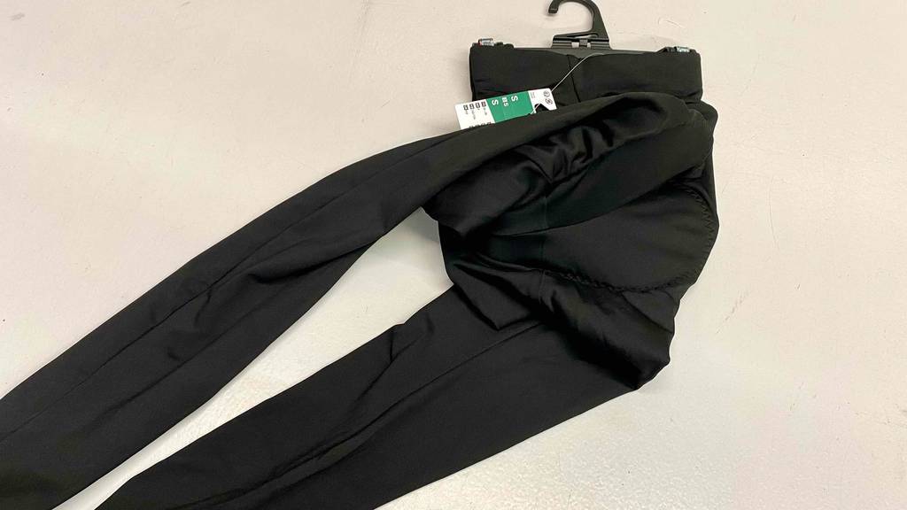 Fahrradhose-Damen getestet: lange Fahrradhose in der Farbe schwarz liegt auf einer weißen Fläche.