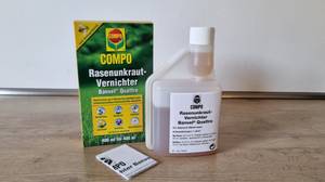 Ein Unkrautvernichter und dessen Verpackung, mitsamt Handbuch.