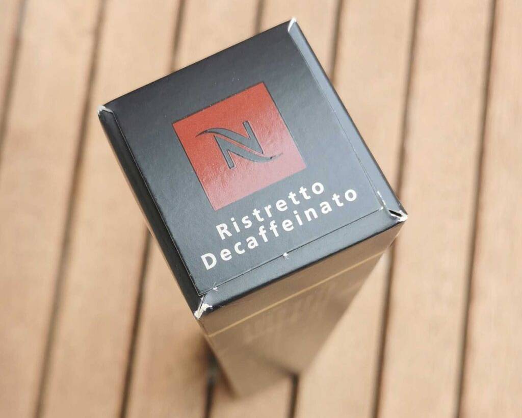 Auf einem Holzuntergrund steht eine Packung des getesteten entkoffeinierten Kaffees hochkant.