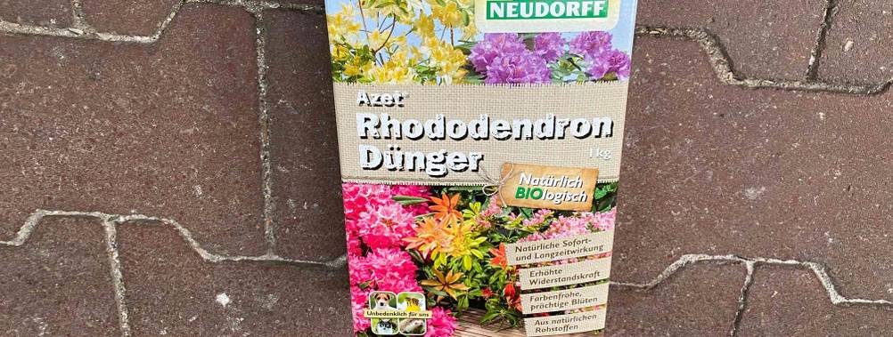 Rhododendron-Dünger im Test: Eine Packung umgedreht auf einem Steinboden