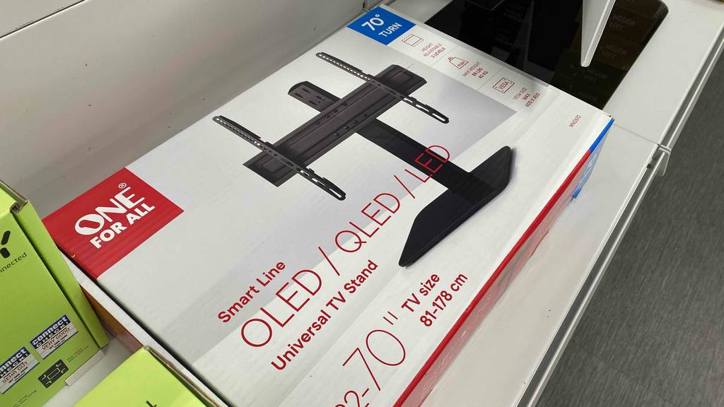 Im Test: Ein verpackter TV-Ständer auf einer hellen Oberfläche neben anderen Produkten.
