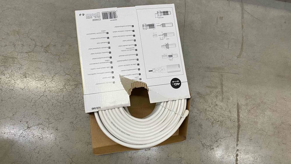 Koaxialkabel getestet: Die Rückseite einer Verpackung bei der das Kabel hervorschaut auf einem grauen Boden.