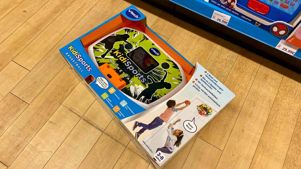 Kinder-Basketballkorb getestet: Ein verpackter Korb auf einer Holzfläche vor einem Regal.