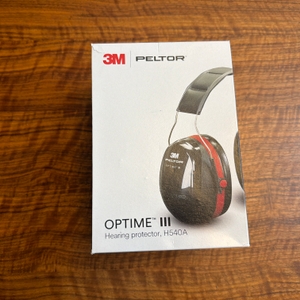 Der Karton des 3M Peltor Optime III liegt auf einem Tisch.