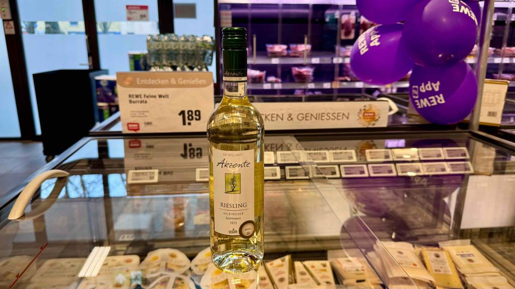 Test: Eine Flasche Riesling steht auf einer Glasoberfläche einer Kühltruhe.