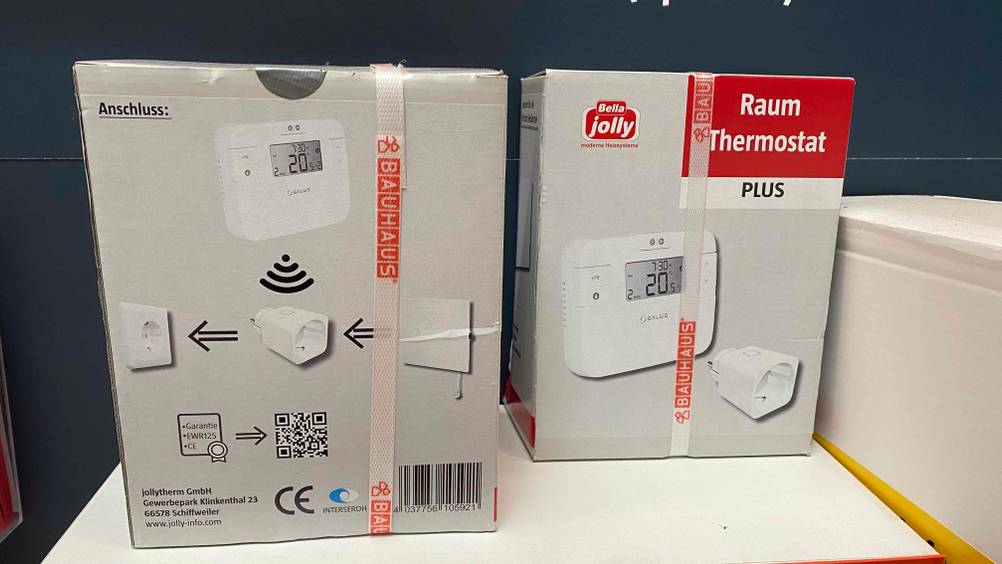 Raumthermostat getestet: Zwei verpackte Raumthermostate stehen nebeneinander in einem Regal.