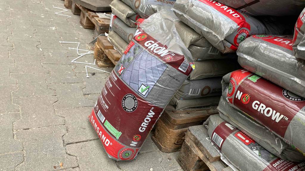 Fugensand-Test: einige Säcke Fugensand sind auf Paletten platziert, wobei einer davor angelehnt ist.