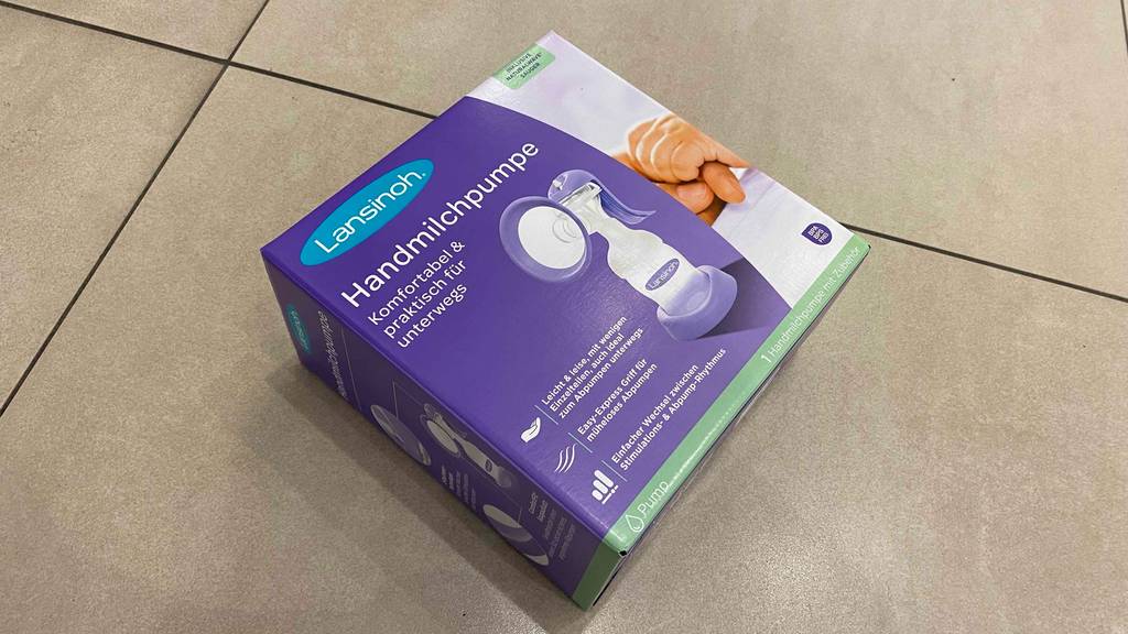 Im Test: Auf einem hellen Boden liegt eine verpackte Handmilchpumpe.