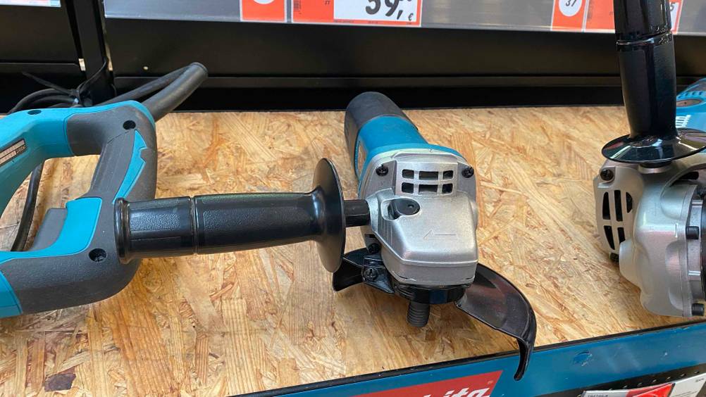 Im Test: Ein Makita-Winkelschleifer 125 in einem Regal neben anderen Produkten.