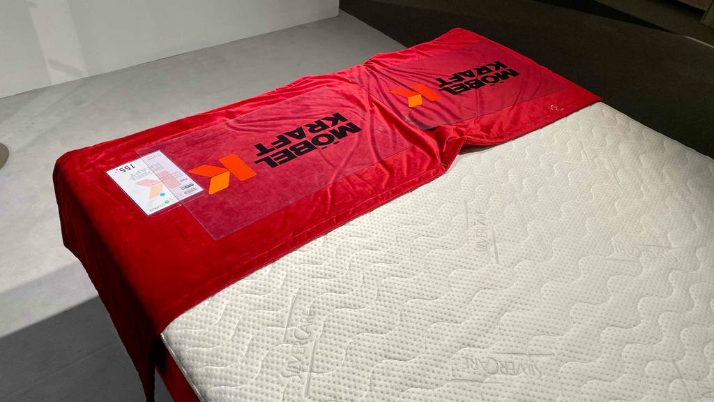 Boxspringbett-160x200 im Test: Fußteil eines Boxspringbettes mit Schutz und Preisschild darauf.