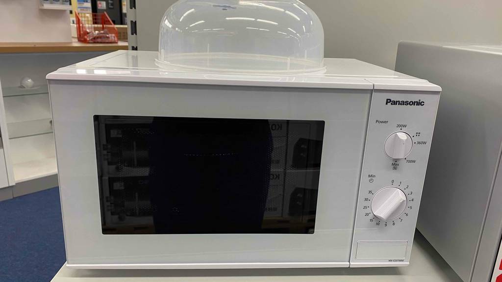 Eine getestete Panasonic-Mikrowelle von vorne auf einer hellen Fläche.