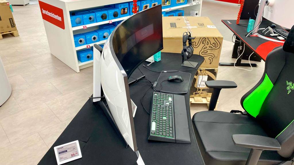 49-Zoll-Curved-Monitor getestet: ein Curved-Monitor stehend auf einem Schreibtisch in einem Geschäft.