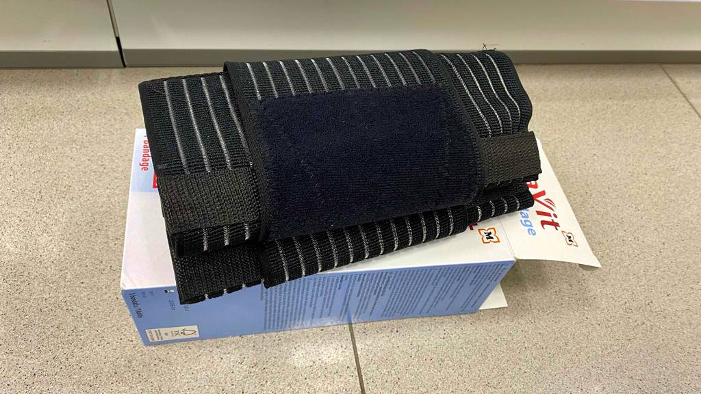 Eine getestete Rückenbandage liegt auf der entsprechenden Verpackung.