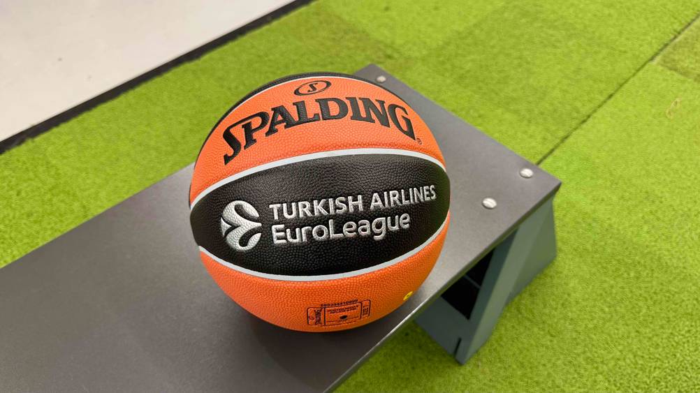 Der Spalding-Basketball, der getestet wurde in der Farbe Orange und Schwarz, liegt auf einer Sitzbank.