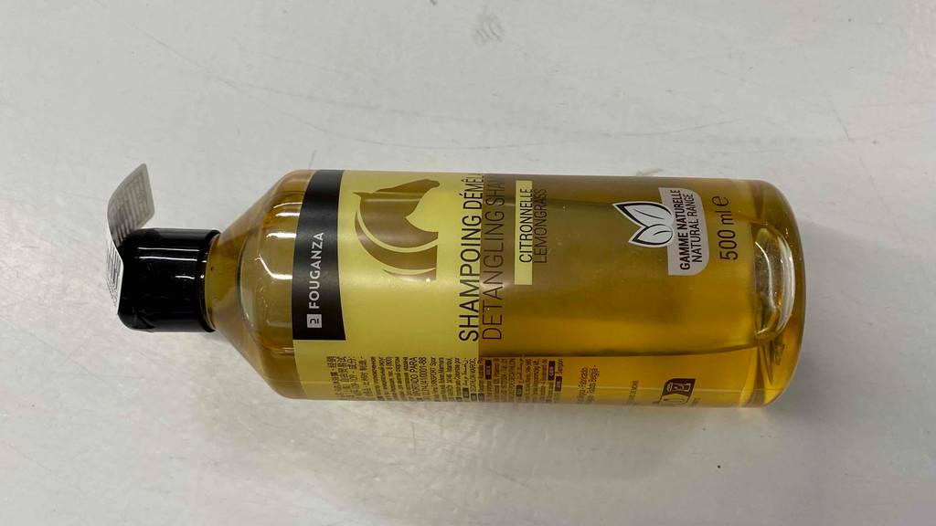 Pferdeshampoo im Test: Eine Flasche liegt horizontal auf einer hellen Oberfläche