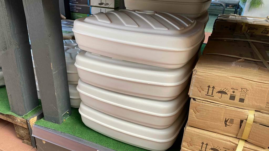 Schirmständer-Test: vier weiße Schirmständer sind übereinander gestapelt.