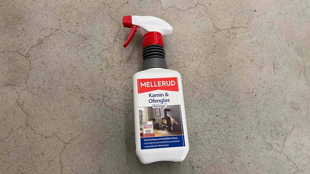 Getesteter Mellerud-Kaminreiniger im Test liegt in einer 500-ml-Sprühflasche auf grauem Untergrund.