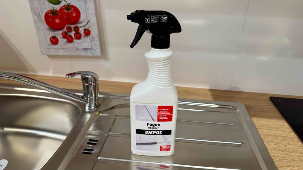 Fugenreiniger-Test: Die weiße Flasche mit schwarzem Sprühaufsatz steht auf einer Küchenspüle.