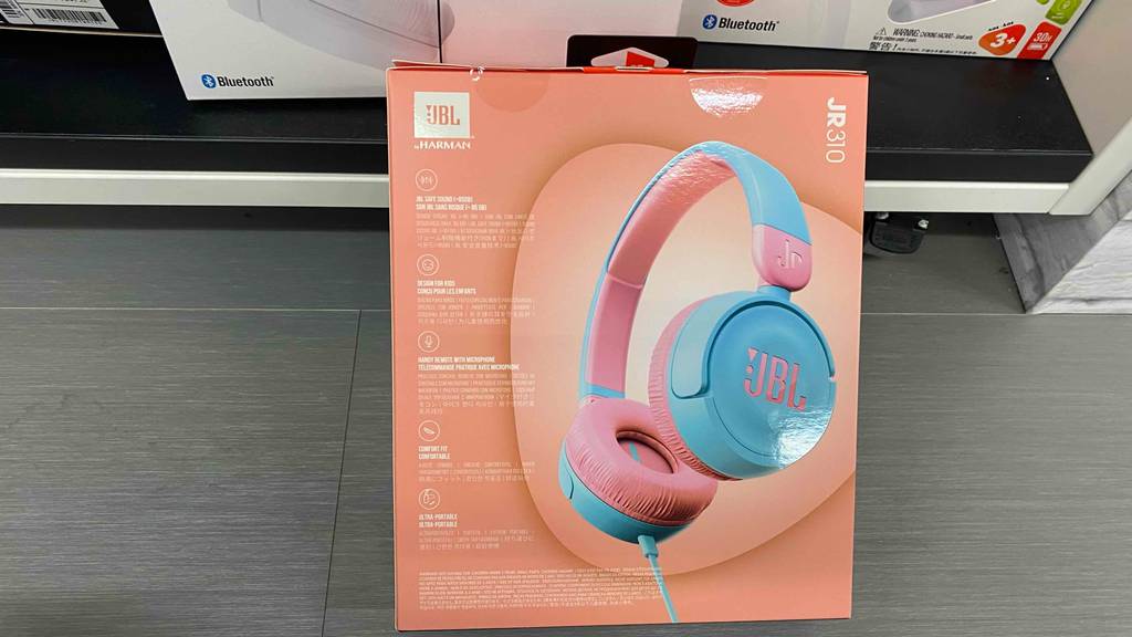Im Test: Ein verpackter Bluetooth-Kopfhörer für Kinder lehnt an einem Regal.