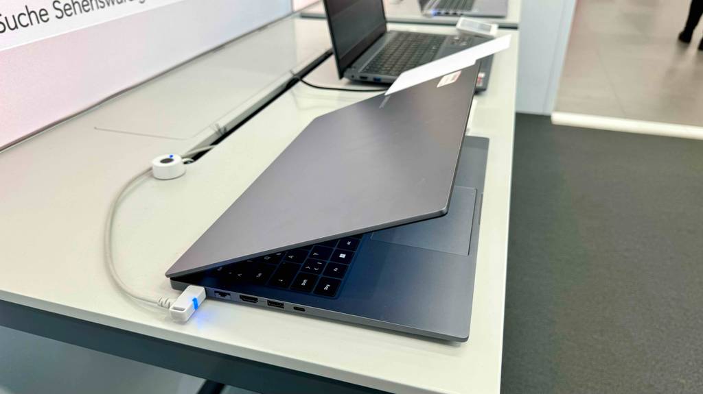 Im Test: Das Laptop bis 800 Euro steht angeschlossen mit herabgelassenem Display auf einem Ausstellungstisch im Geschäft.