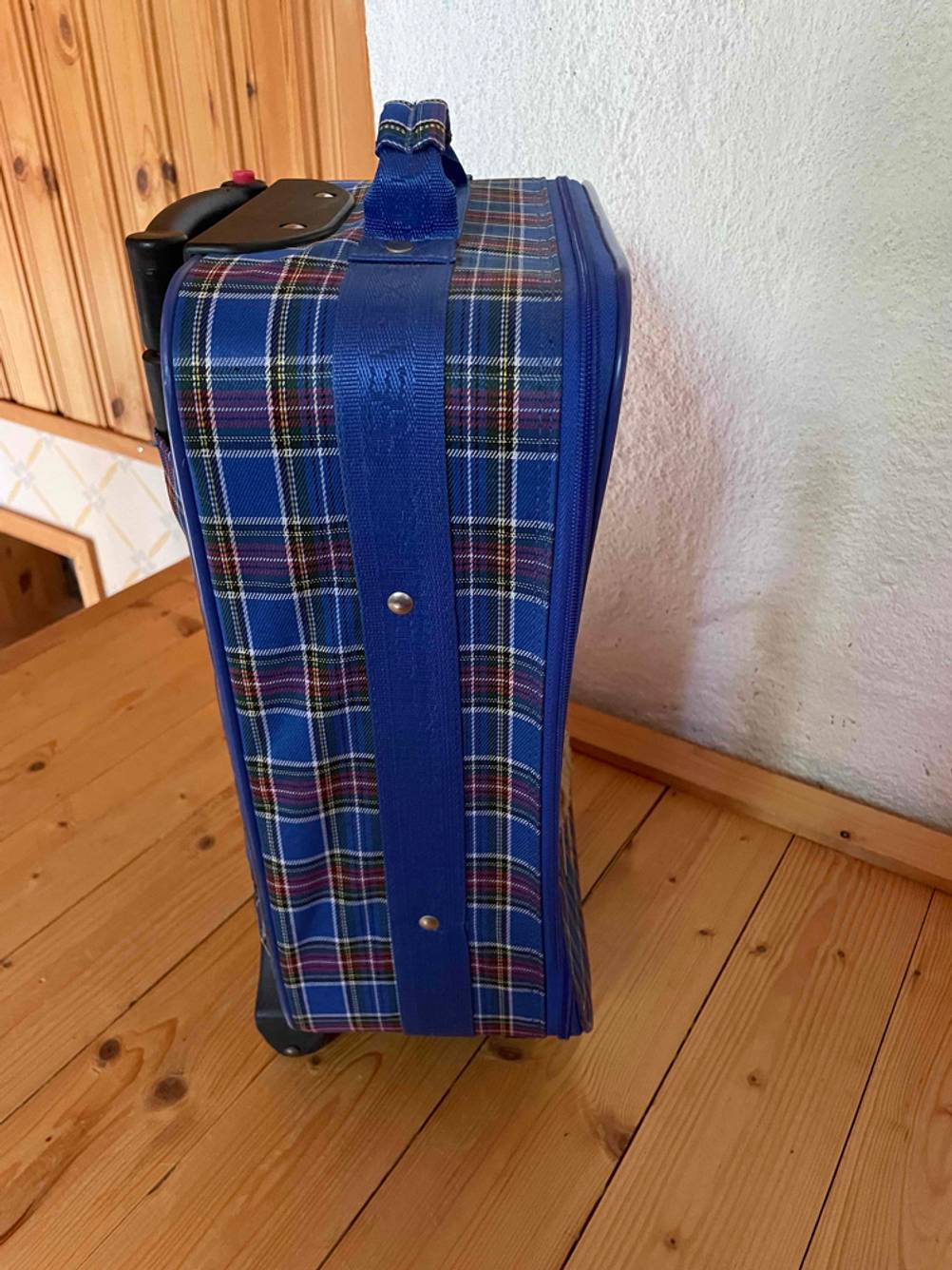 Kinderkoffer im Test: Kinderkoffer von der Seite vor einer hellen Wand auf einem Holzboden