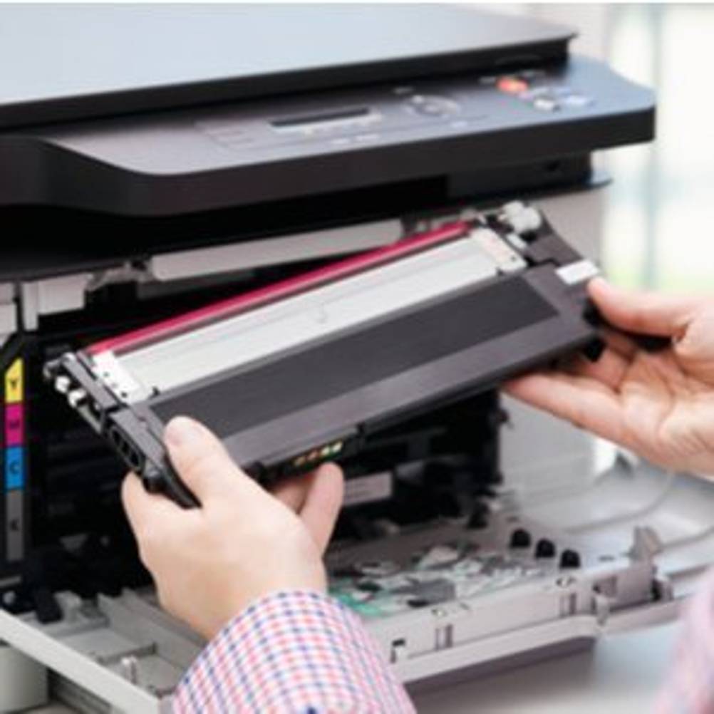 Frau setzt Toner-Kartusche in WLAN-Laserdrucker ein