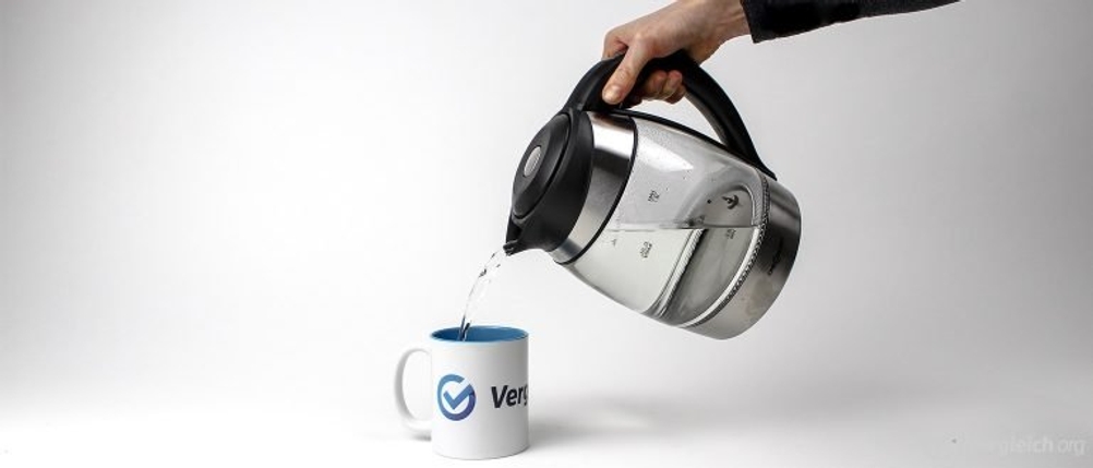Wasser mit einem Wasserkocher in eine Tasse eingießen