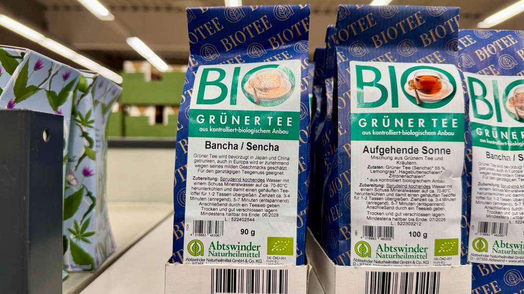 Bancha-Tee im Test: Mehrere Verpackungen mit grünem Biotee befinden sich nebeneinander auf einem Verkaufsregal.